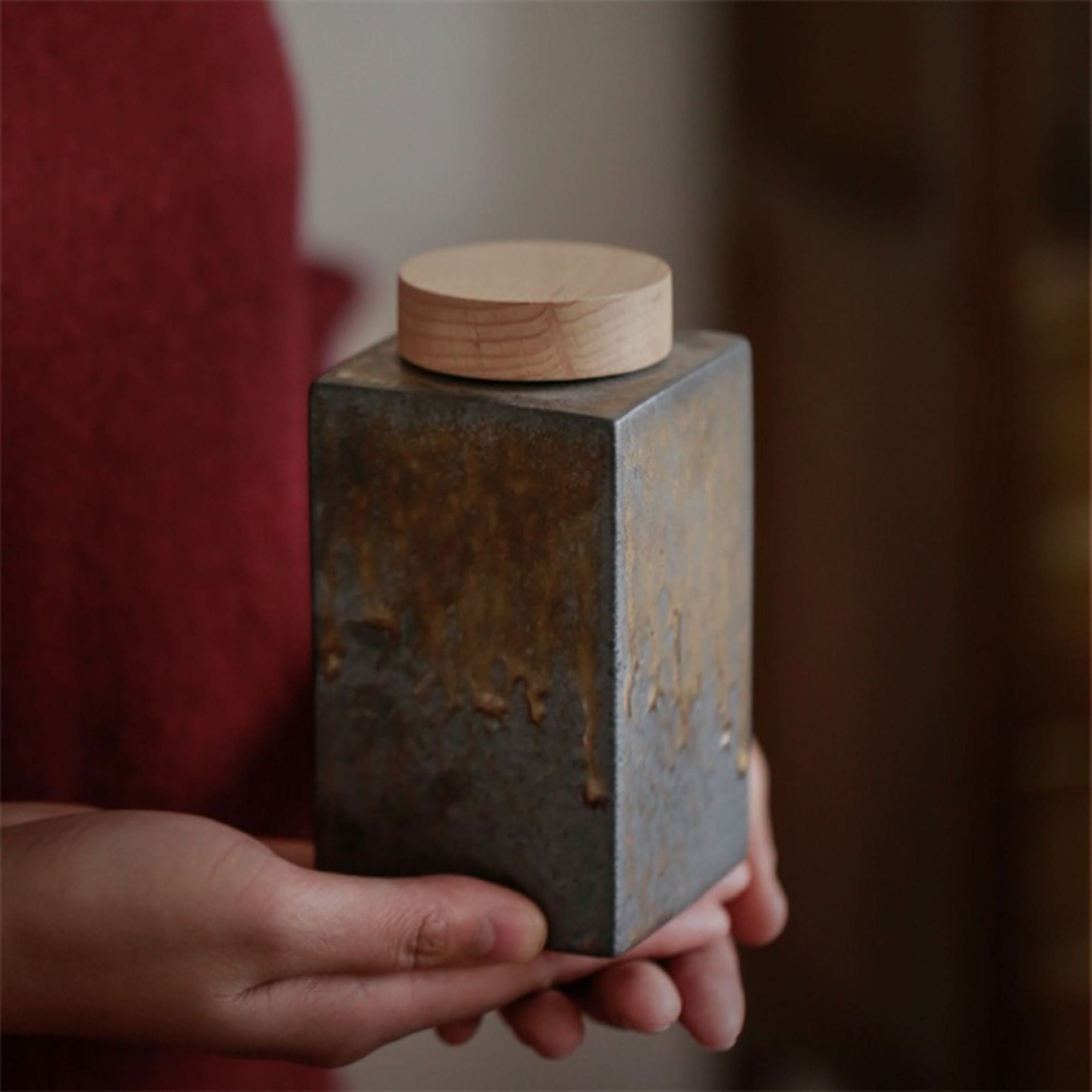 Gray ceramic tea jar with wood lid, rustic home decor.